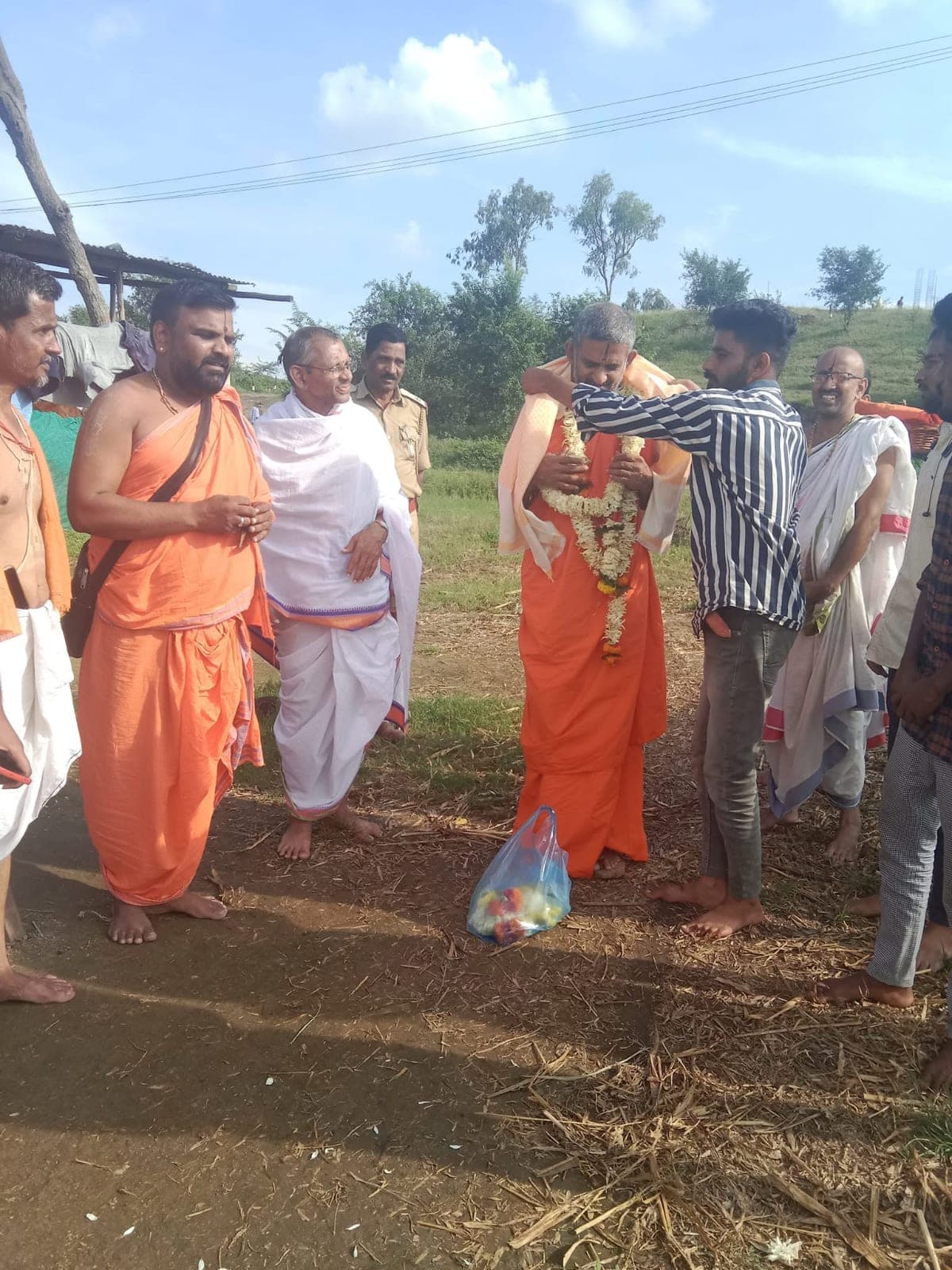 Honouring a visiting Swami with a garland
