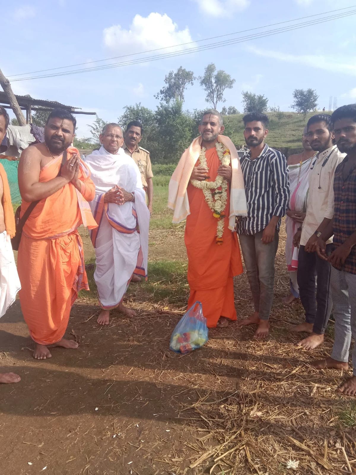 Walking alongside a Swami during a village visit